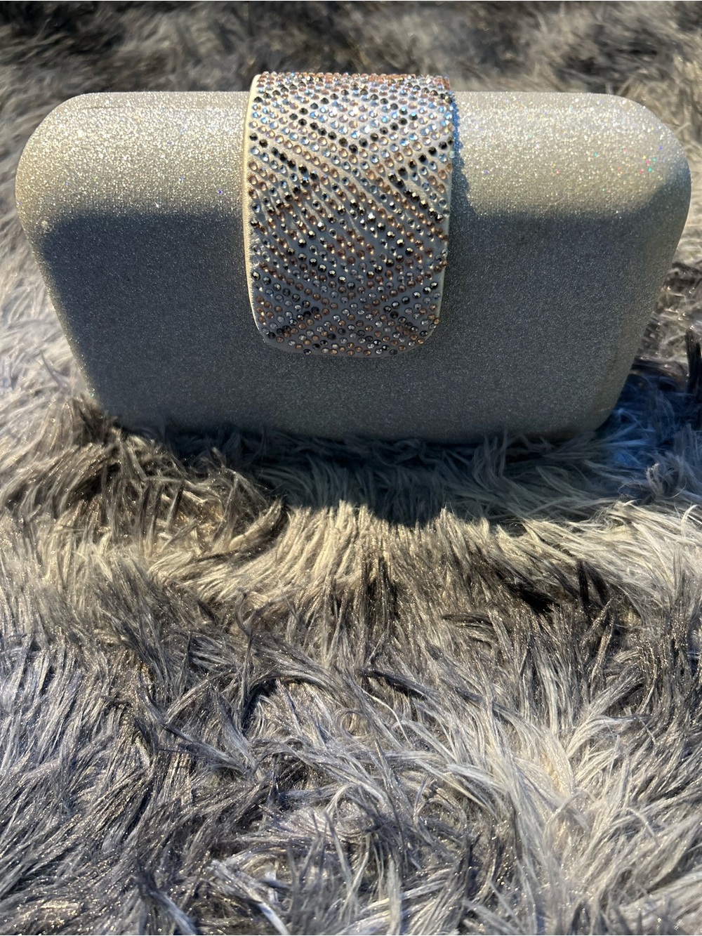 Rigid silver evening pouch with geometric rhinestone clasp